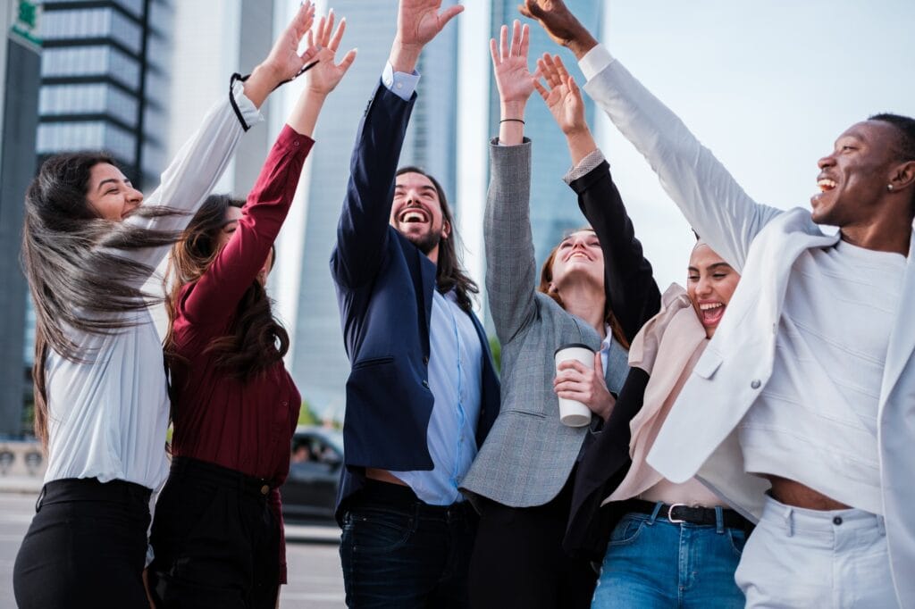 Business group celebrating the successes of the company outdoors in the financial district